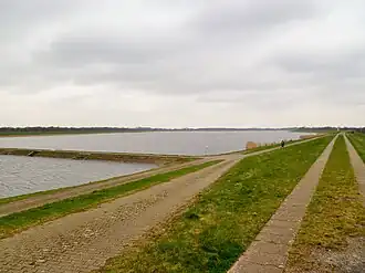 Alfsee mit Überlaufdamm zwischen Absetzbecken (vorne) und Hauptbecken