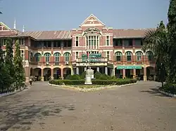 Dreistöckiges Gebäude der St. Paul’s High School in Botataung mit dem Vorstechenden Eingangsbereich.