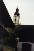 Kreuzkirche hinter alpenländischen Häusern