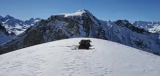 Steinmann auf dem Gipfel, Piz d’Emmat Dadaint im Hintergrund.