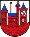 Wappen von Hamminkeln-Wertherbruch, auf dem linken Turm hängt über einem Torbogen mit Fallgitter ein silberner (weißer) Schild mit einem gekrönten und doppeltgeschwänzten schwarzen Löwen
