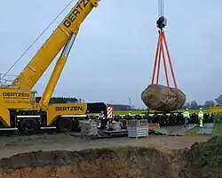 Verlastung auf einen Tieflader mit dem Erdloch im Vordergrund