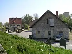 Steingebäude mit weiterem Gebäude im Hintergrund und Hof