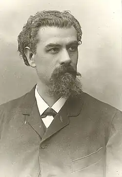 Franz von Wieser mit längeren Haaren und Bart in dunklem Anzug