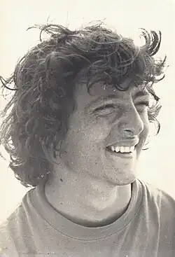 Gerry Roufs lacht mit vom Wind zerzausten lockigen Haaren