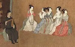„Nachtbankett des Han Xizai“. Der Hofmusikdirektor links mit einer Klapper paiban, die Frauen spielen zwei Doppelrohrblatt­instrumente guan und drei Querflöten dizi. Gemälde des 12. Jh.