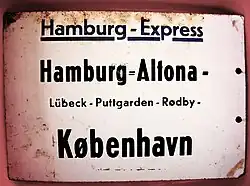 Zuglaufschild mit Doppel­binde­strich im Bahn­hofs­namen Hamburg-Altona