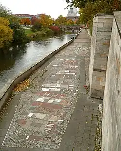 Uferpromenade mit Pflastermosaiken zu Stadtmotiven