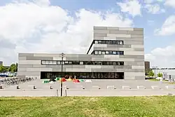 Gebäude, bestehend aus zwei Rechtecken und einer Glasfront in der ersten Etage.