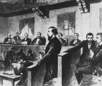 August Bebel (erster von rechts) und Wilhelm Liebknecht (Mitte stehend) werden in Leipzig wegen ihrer Opposition gegen den Deutsch-Französischen Krieg wegen Hochverrats verurteilt