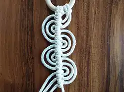 Die 3 Arbeits­fäden, die hier an 1 Träger­faden entlang­geführt werden, bilden Rippen­knoten und Buchten.[114]