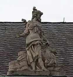 50. Militärwesen – Kriegerin, Putto, Stockbündel.