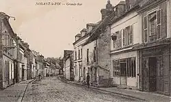 Zentral gelegene Straße in Nonant-le-Pin auf einer Postkarte vom frühen 20. Jahrhundert