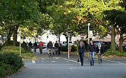 Menschen sind auf getrennten Wegen zu Fuß und mit dem Fahrrad unterwegs.