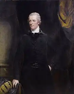 Das Bild zeigt William Pitt den Jüngeren zentral stehend. Hinter ihm ist ein Vorhang drapiert vor einer Wand. Pitt trägt einen schwarzen Anzug, seine rechte Hand ruht auf einem Stuhl, sein Gesicht ist im Vergleich zu früheren Porträts bereits deutlich gealtert