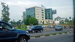 Dicht befahrene Straße mit einem Hochhaus im Hintergrund