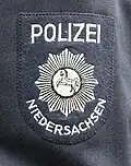 Ärmelabzeichen der alten blau/grauen Uniform bis 1976