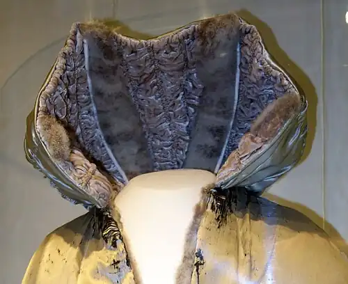 Die Kapuze aus gesmoktem Samt und Federfell