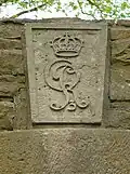 Schlussstein über einem Torbogen mit den Insignien von König Georg III.