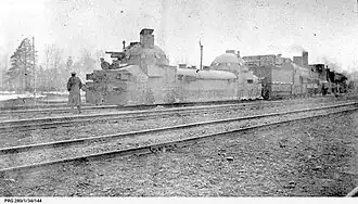 Der Panzertriebwagen hinter einer Dampflokomotive 1918