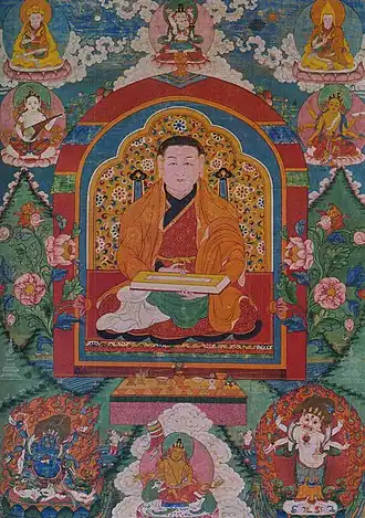 Das Gemälde ist voller Details. Mehrere Personen und Wesen sind um die in der Mitte sitzende Person angeordnet.